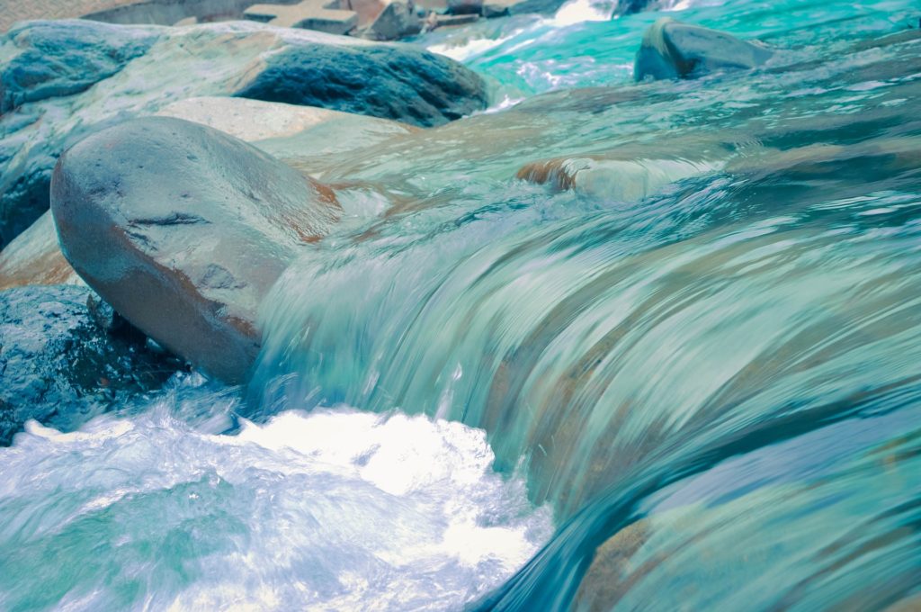 water flowing over a rock