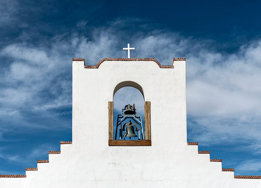 Mission church with cross and blue sky