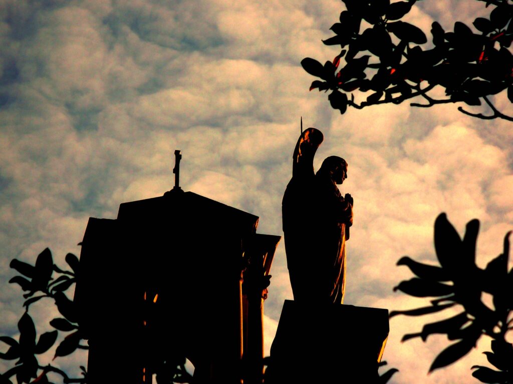 Angel of God Watching Over the Church with light filled clouds and sky